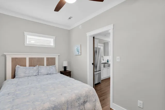 a bedroom with a bed and painting on the wall