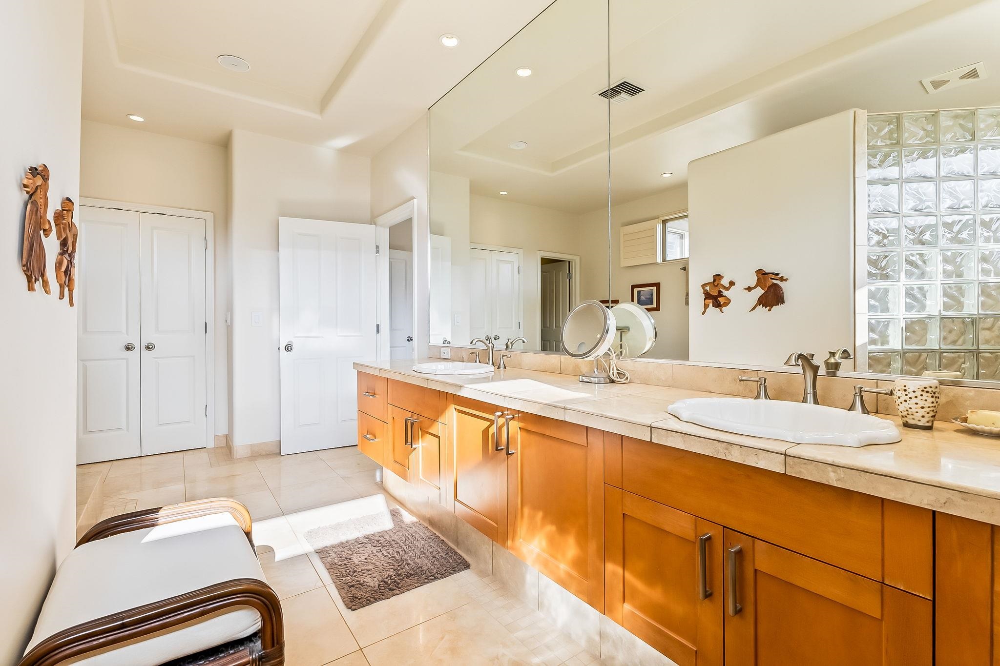302 Kahana Ridge Drive Lahaina, HI 96761 - Photo 19 of 50 a spacious bathroom with a double vanity sink a mirror and a shower