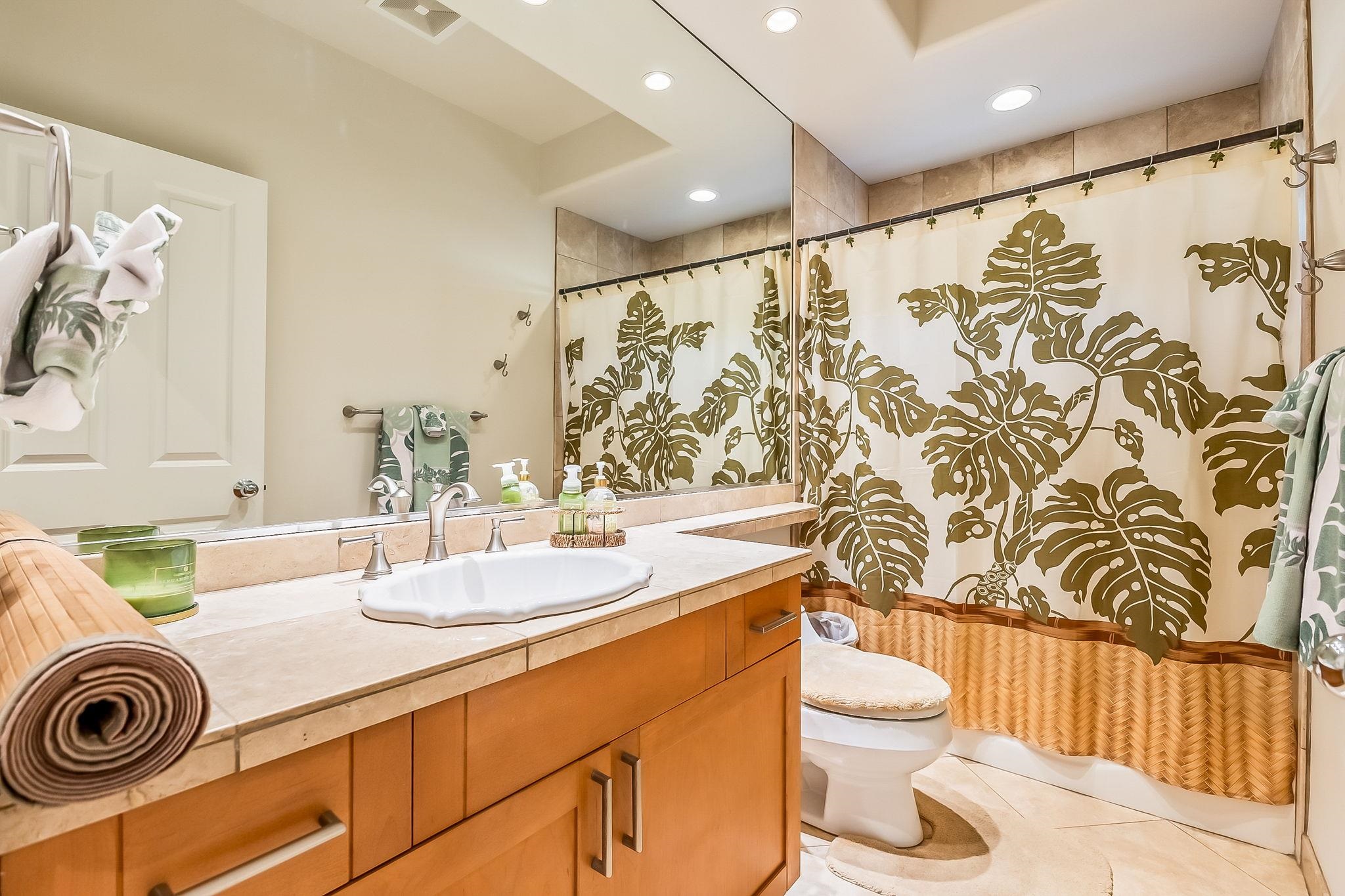 302 Kahana Ridge Drive Lahaina, HI 96761 - Photo 28 of 50 a bathroom with a sink a toilet and shower curtain