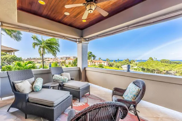 a view of a swimming pool with lawn chairs and a big yard