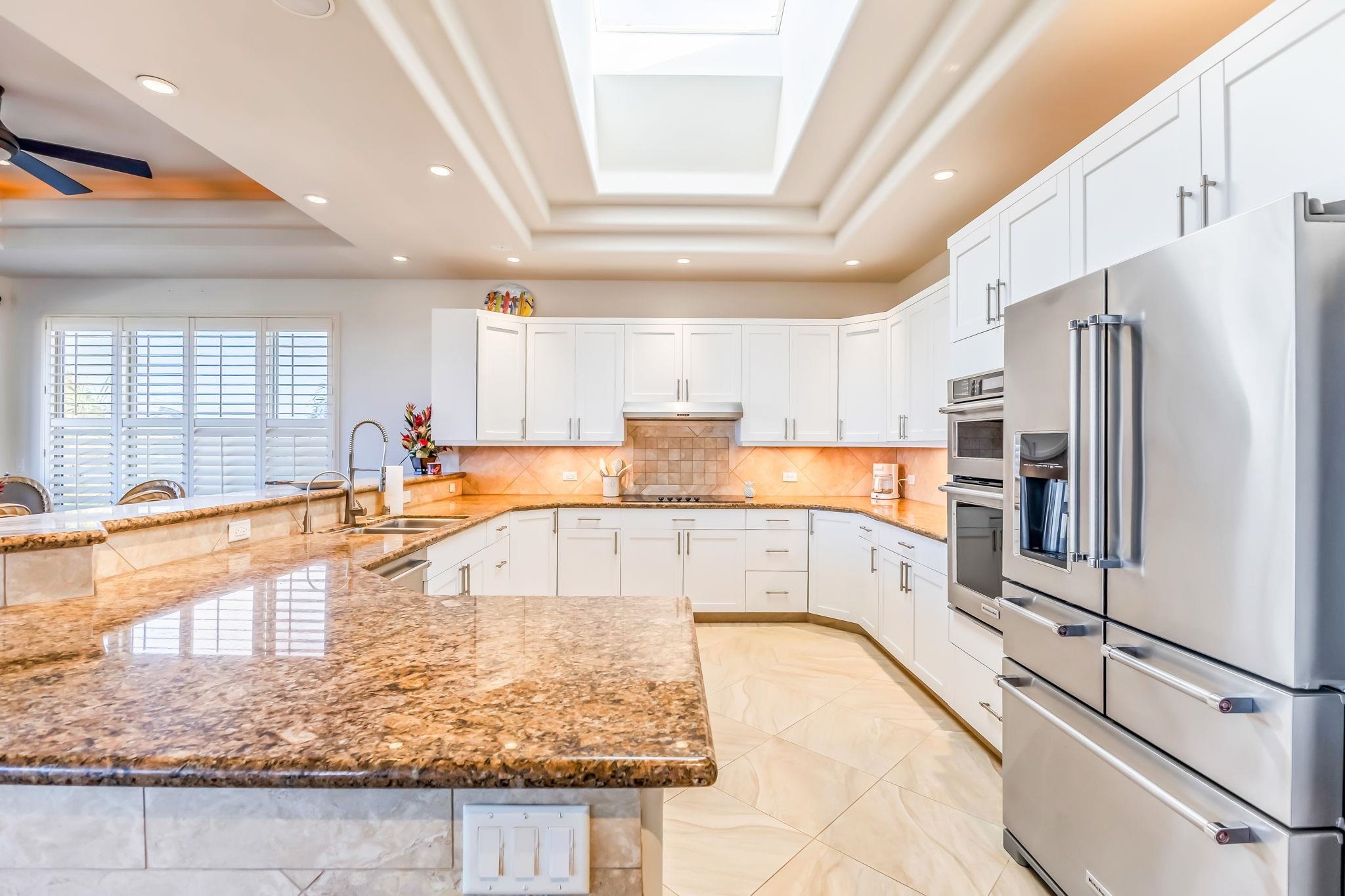 302 Kahana Ridge Drive Lahaina, HI 96761 - Photo 8 of 50 a large white kitchen with stainless steel appliances granite countertop a refrigerator and a sink