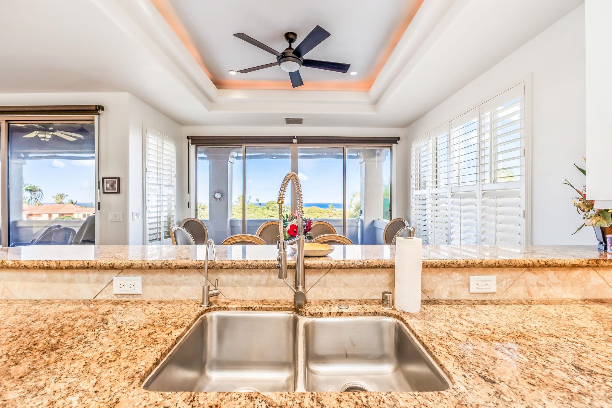 302 Kahana Ridge Drive Lahaina, HI 96761 - Photo 9 of 50 a view of a kitchen with a sink and a dining table