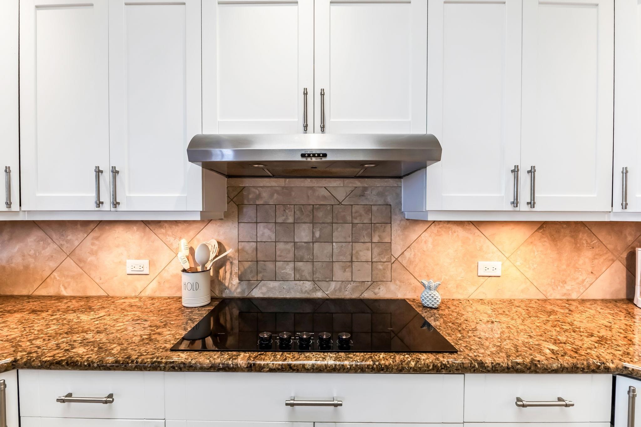 302 Kahana Ridge Drive Lahaina, HI 96761 - Photo 10 of 50 a kitchen with granite countertop a sink and a stove