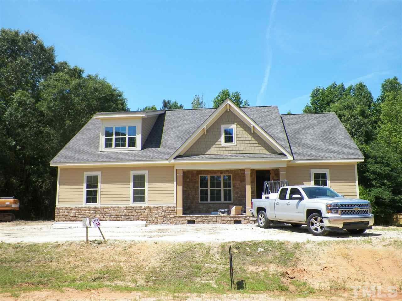 6112 Spring Branch Circle Raleigh, NC 27603 - Photo 1 of 19 a front view of a house with a yard outdoor seating and garage