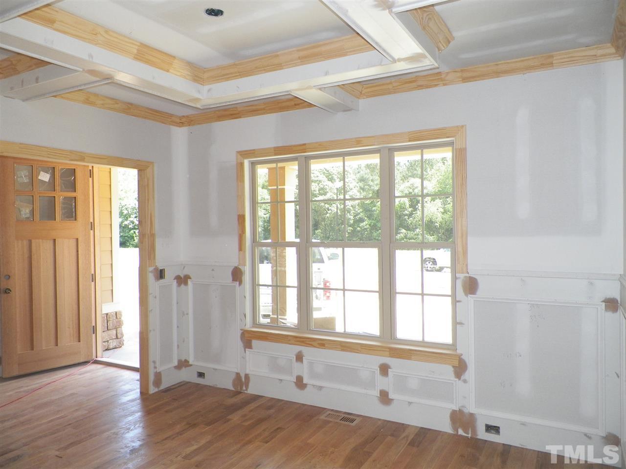 6112 Spring Branch Circle Raleigh, NC 27603 - Photo 4 of 19 a view of an empty room with wooden floor and a window