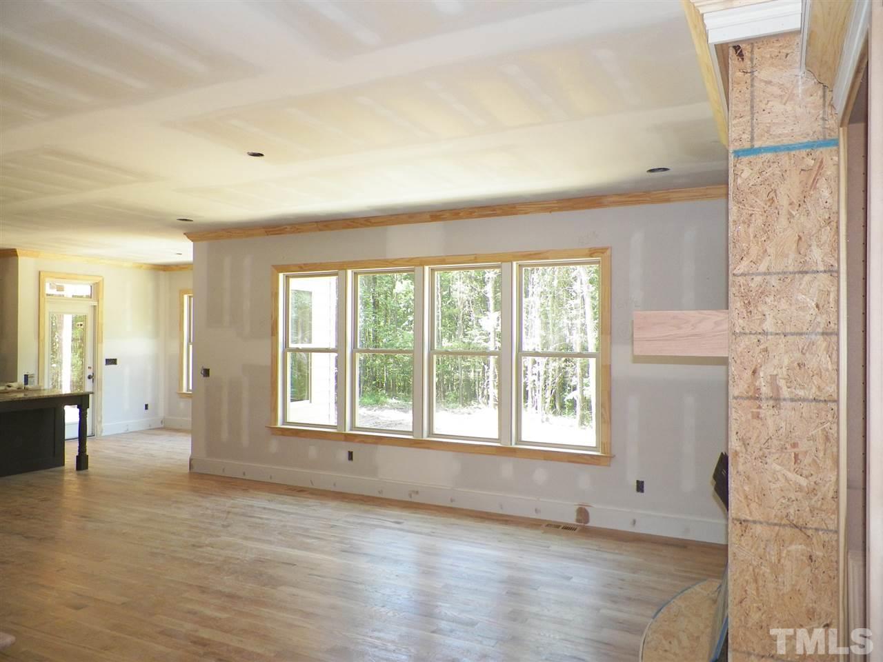 6112 Spring Branch Circle Raleigh, NC 27603 - Photo 7 of 19 a view of an empty room with wooden floor and a window