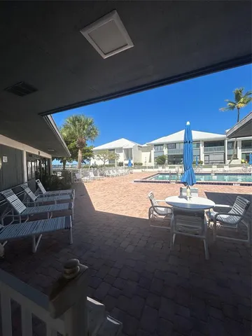 a view of patio with lawn chairs
