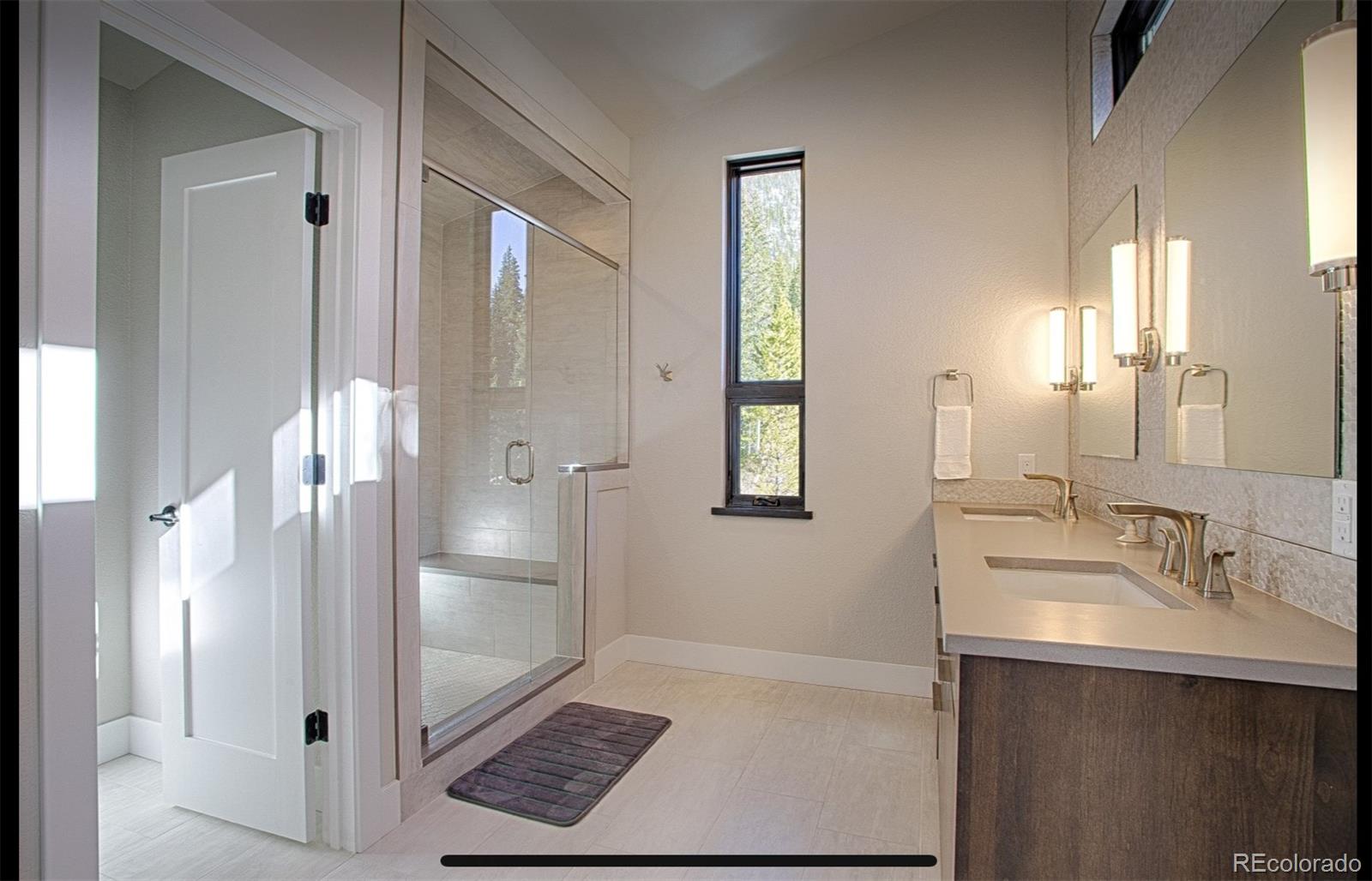 85 Silverheels Road Breckenridge, CO 80424 - Photo 12 of 16 a bathroom with a sink a mirror and a shower
