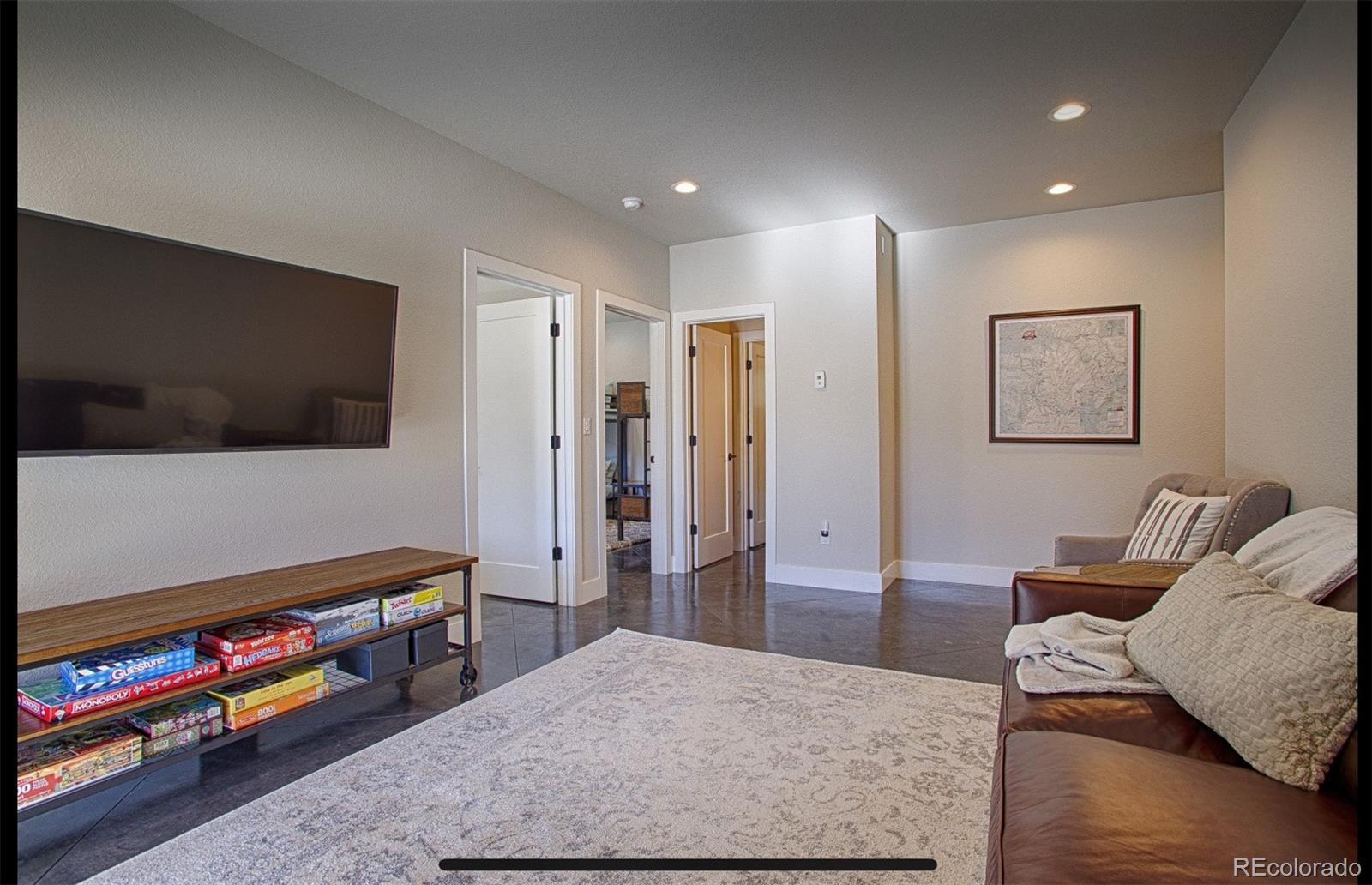 85 Silverheels Road Breckenridge, CO 80424 - Photo 6 of 16 a living room with furniture and a flat screen tv