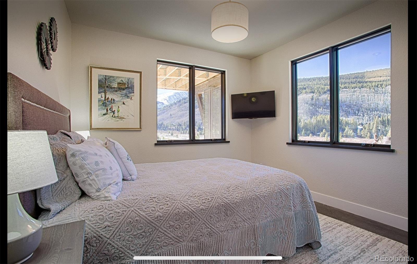 85 Silverheels Road Breckenridge, CO 80424 - Photo 7 of 16 a bedroom with a large bed and a large window