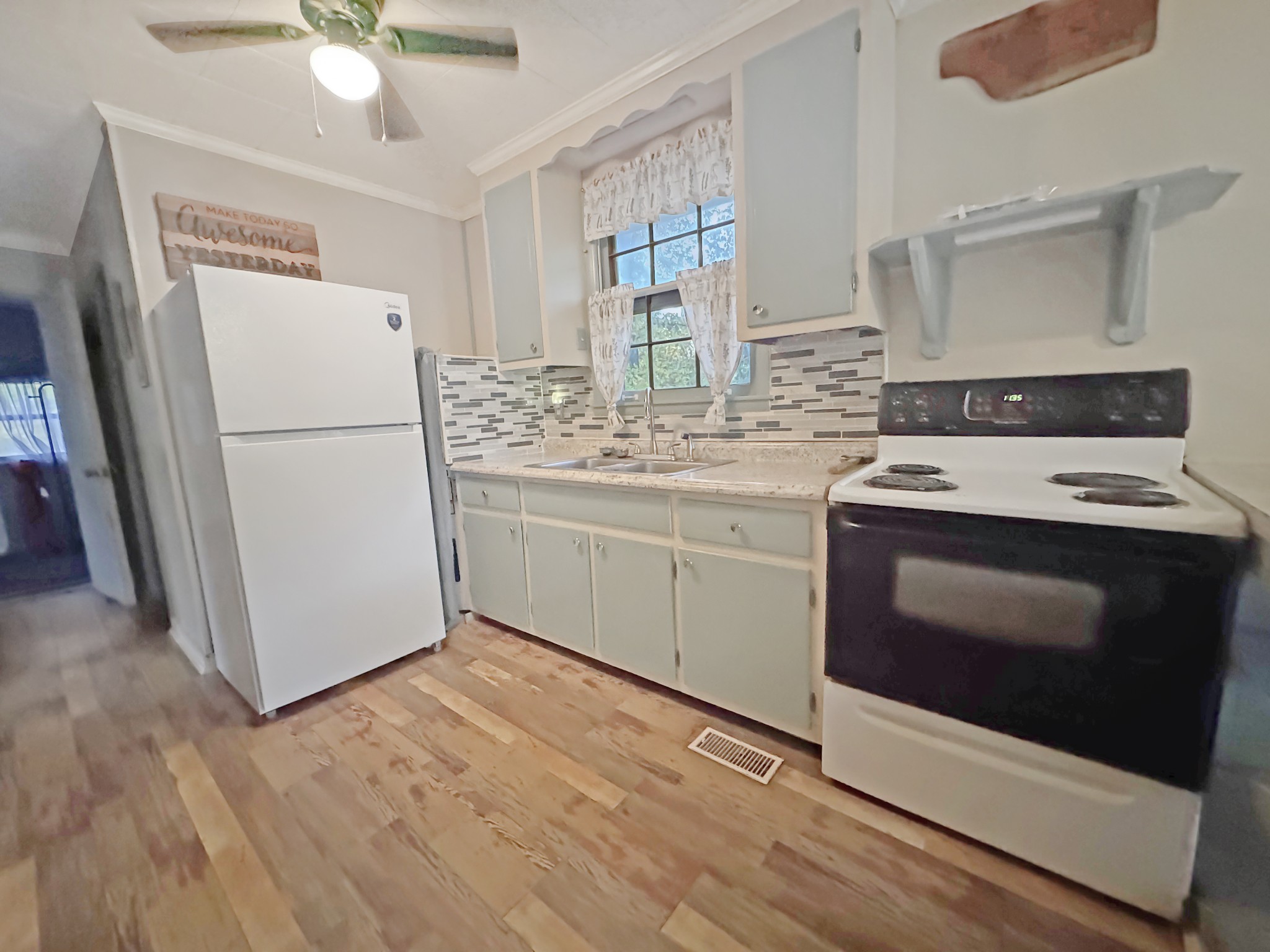 599 Hickman Shores Road Dover, TN 37058 - Photo 5 of 15 a kitchen with a stove sink and refrigerator