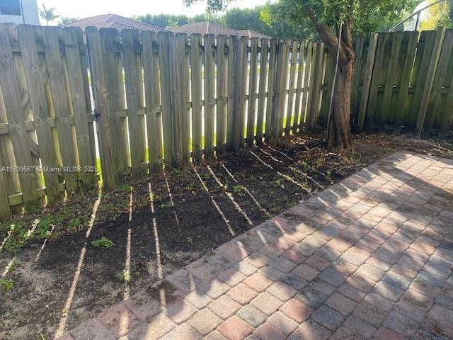 23705 Southwest 117th Court Homestead, FL 33032 - Photo 12 of 22 a view of a backyard with potted plants and wooden fence
