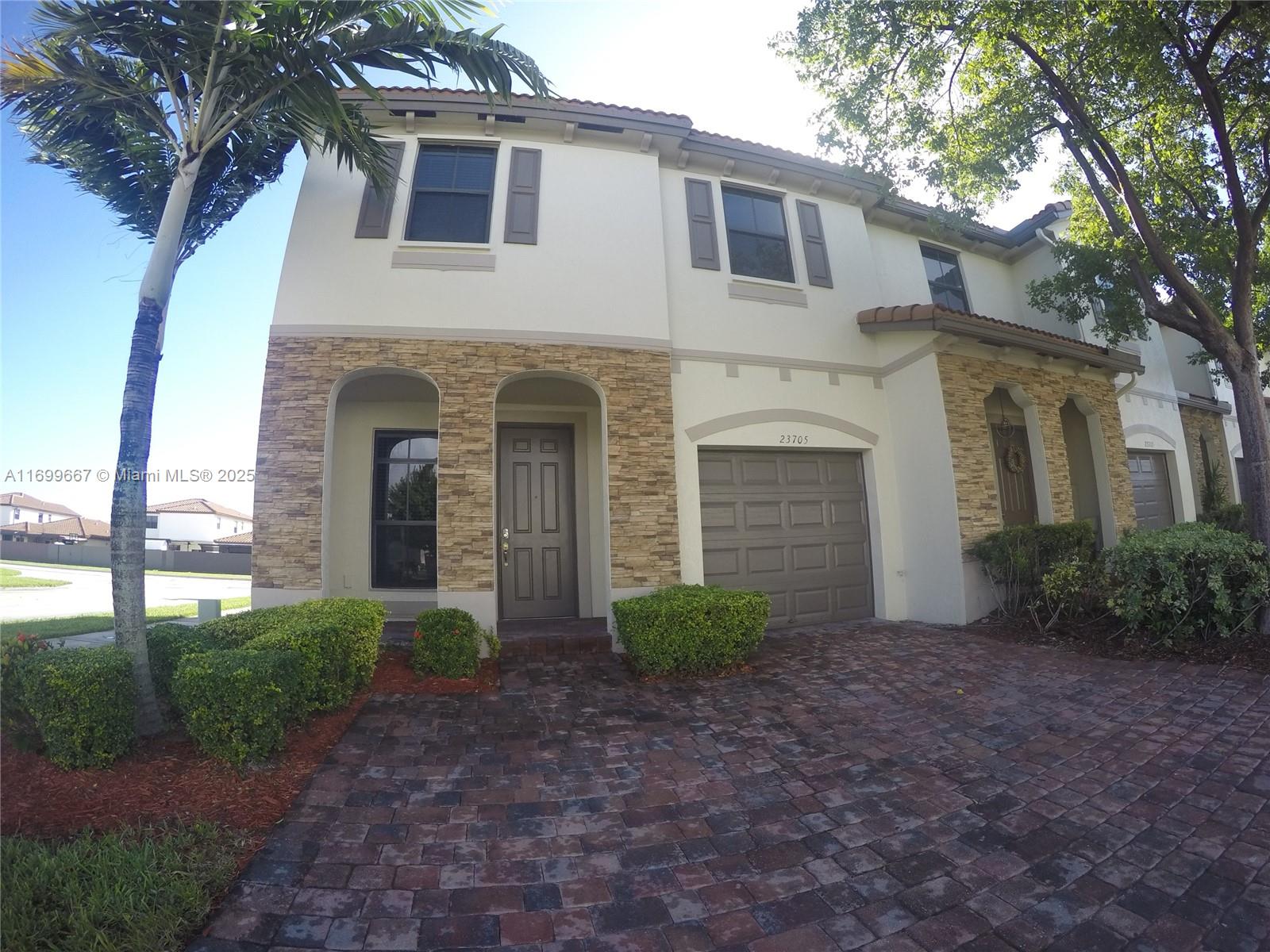23705 Southwest 117th Court Homestead, FL 33032 - Photo 2 of 22 a view of a white house next to a yard with large trees