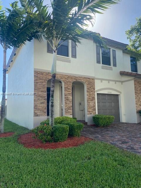 23705 Southwest 117th Court Homestead, FL 33032 - Photo 3 of 22 a front view of a house with a garden