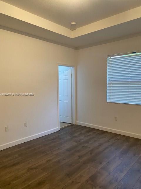 23705 Southwest 117th Court Homestead, FL 33032 - Photo 7 of 22 a view of an empty room with wooden floor and a window