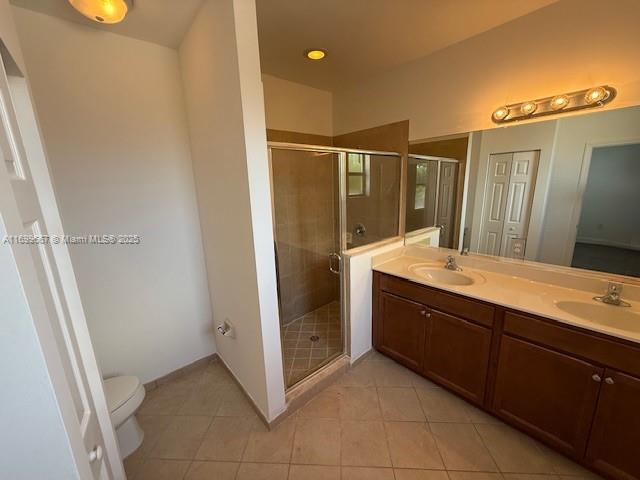 23705 Southwest 117th Court Homestead, FL 33032 - Photo 10 of 22 a bathroom with a double vanity sink and mirror