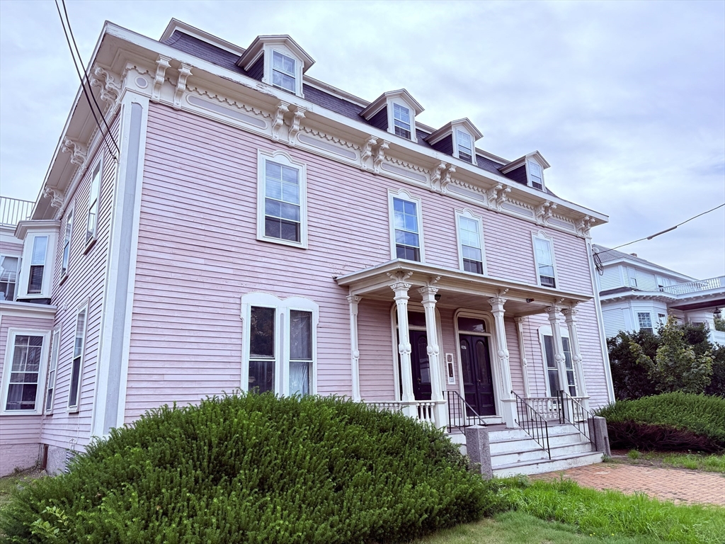 a front view of a house with garden