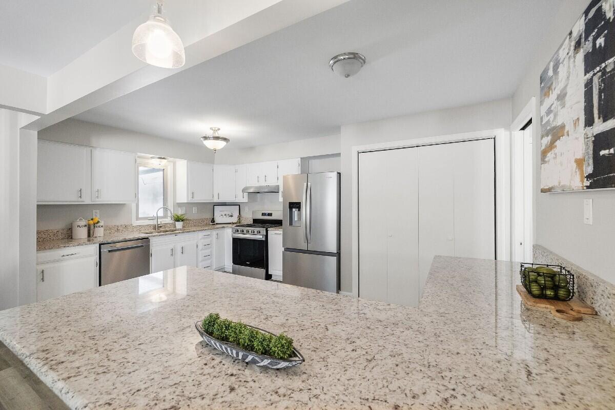 943 Pawnee Drive Crown Point, IN 46307 - Photo 8 of 22 a kitchen with refrigerator and cabinets