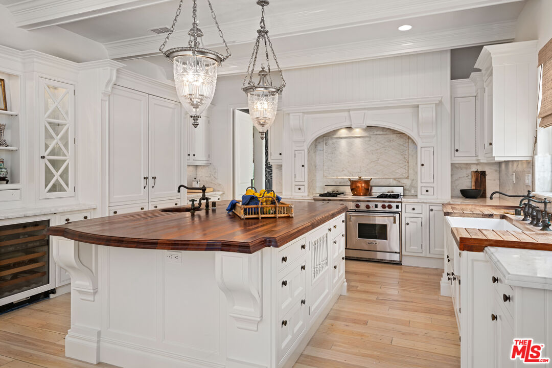 28870 Hampton Place Malibu, CA 90265 - Photo 17 of 53 a kitchen with stainless steel appliances a sink stove and refrigerator