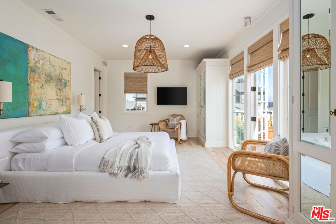 28870 Hampton Place Malibu, CA 90265 - Photo 23 of 53 a living room with furniture a chandelier and a flat screen tv