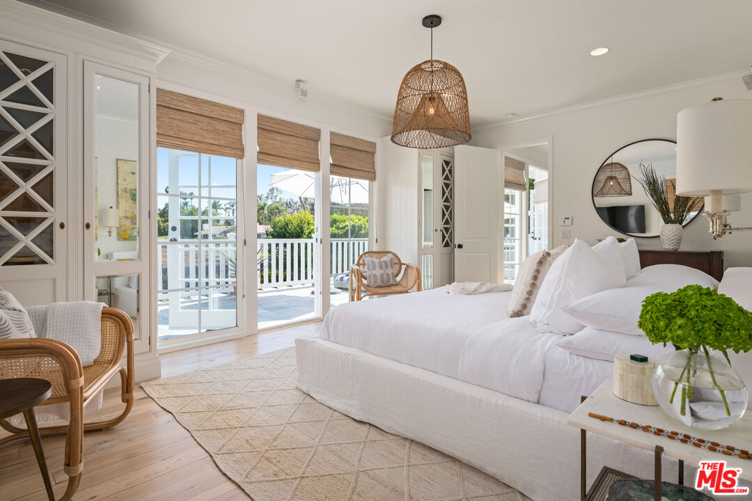 28870 Hampton Place Malibu, CA 90265 - Photo 33 of 53 a bed room with a bed and a chandelier