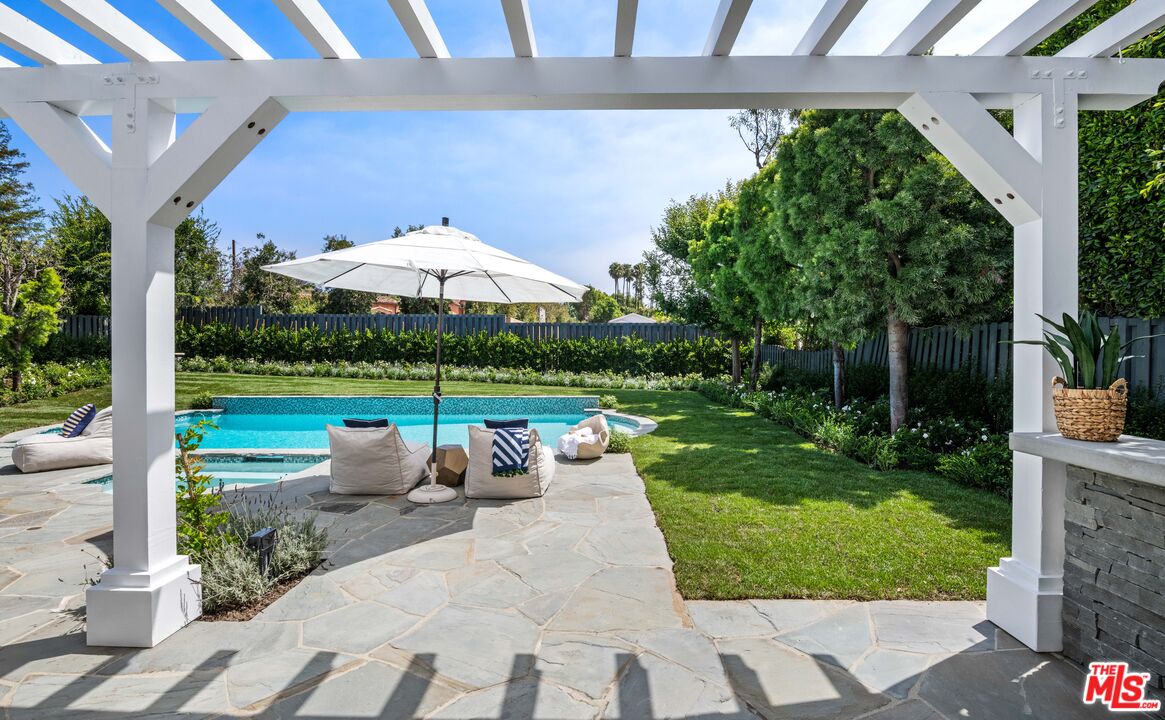 28870 Hampton Place Malibu, CA 90265 - Photo 39 of 53 a view of a patio with a table chairs and a yard