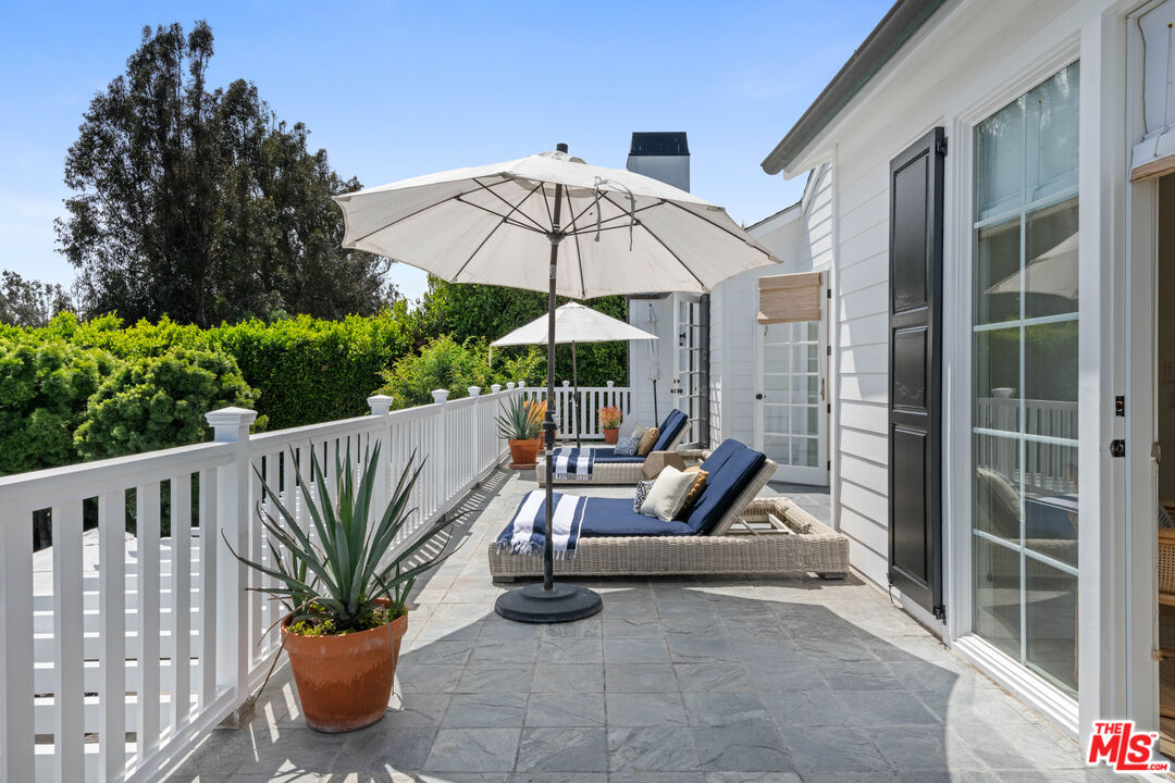28870 Hampton Place Malibu, CA 90265 - Photo 44 of 53 a view of balcony with furniture and umbrella