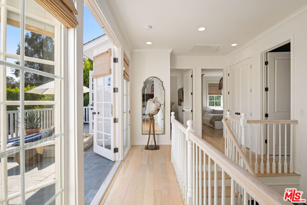 28870 Hampton Place Malibu, CA 90265 - Photo 49 of 53 a view of a hallway view with large windows and kitchen view