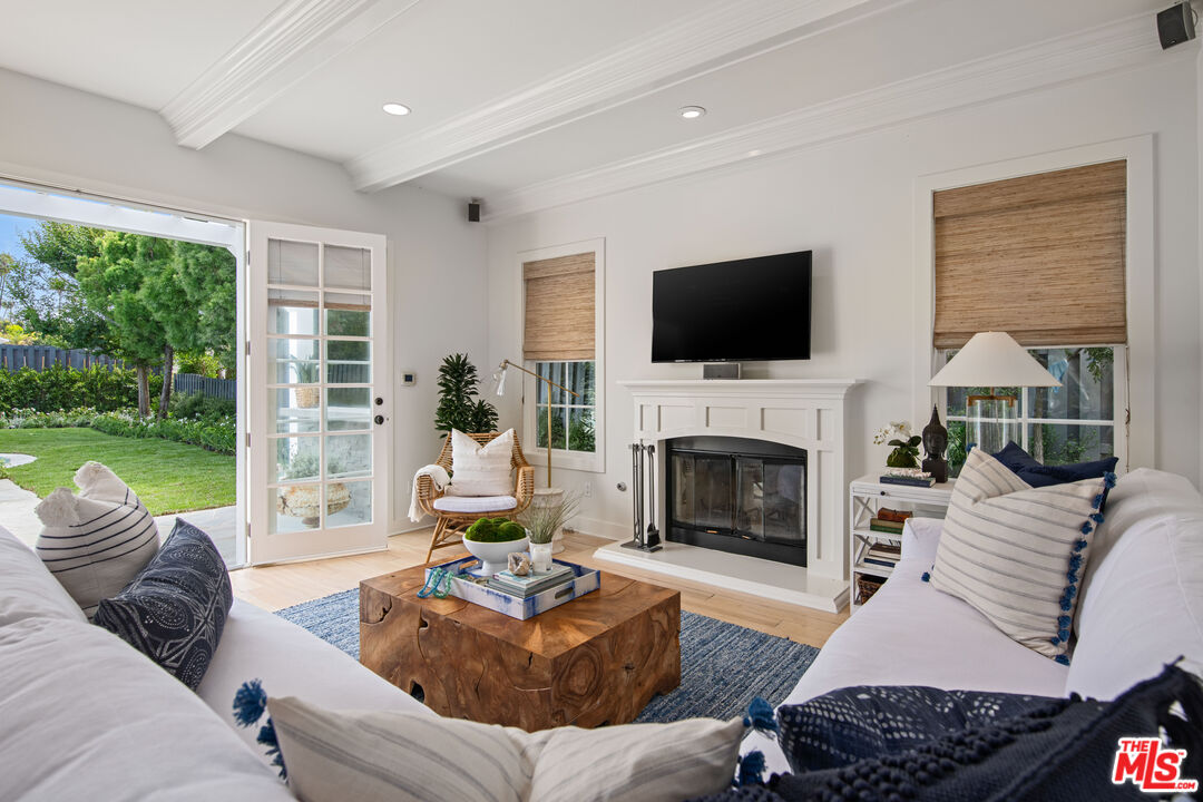 28870 Hampton Place Malibu, CA 90265 - Photo 50 of 53 a living room with furniture a fireplace a flat screen tv and a large window