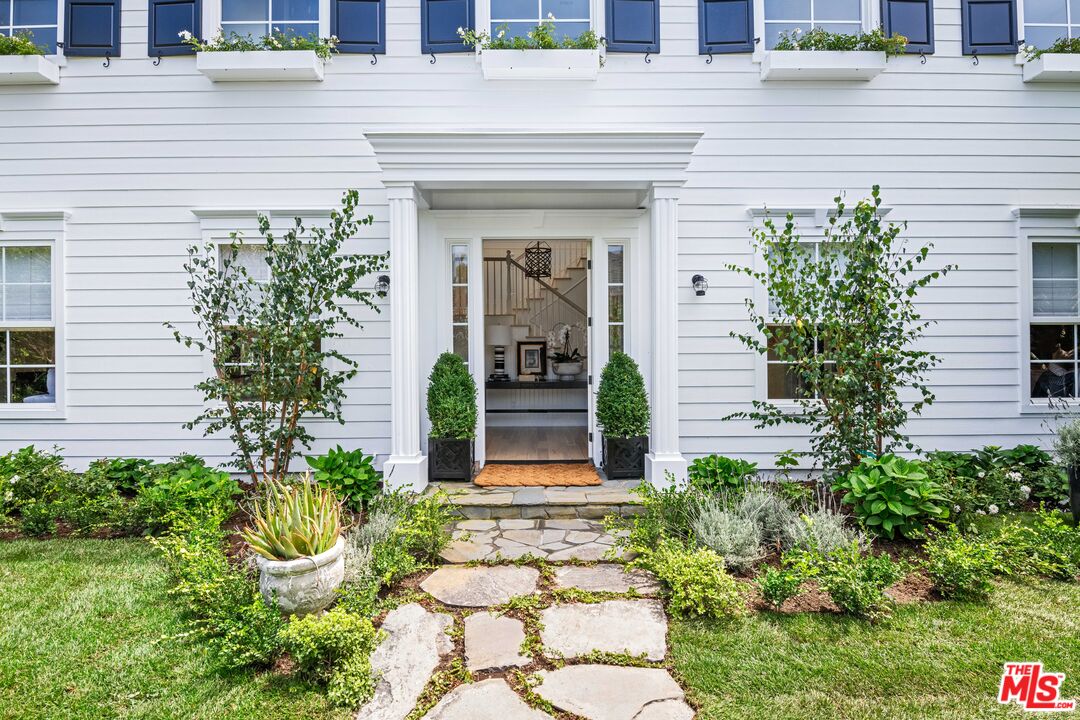 28870 Hampton Place Malibu, CA 90265 - Photo 5 of 53 a front view of a house with a garden
