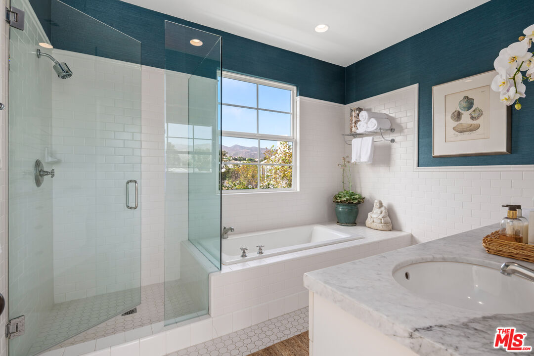 28870 Hampton Place Malibu, CA 90265 - Photo 9 of 53 a bathroom with a tub a sink and glass door