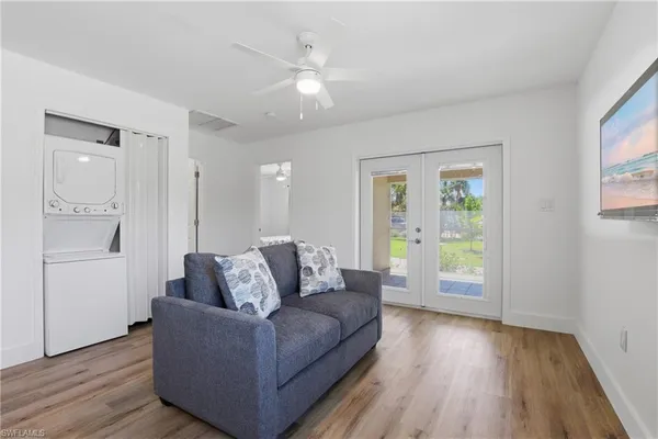 a living room with furniture and kitchen view
