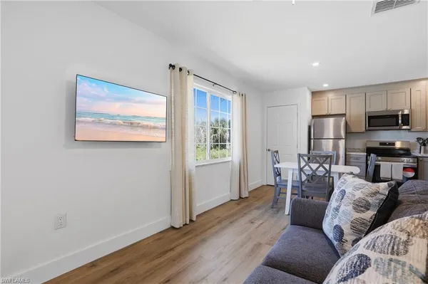 a living room with furniture and kitchen view