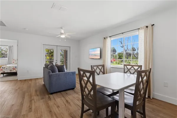 a kitchen with a table a refrigerator a stove a dining table and chairs