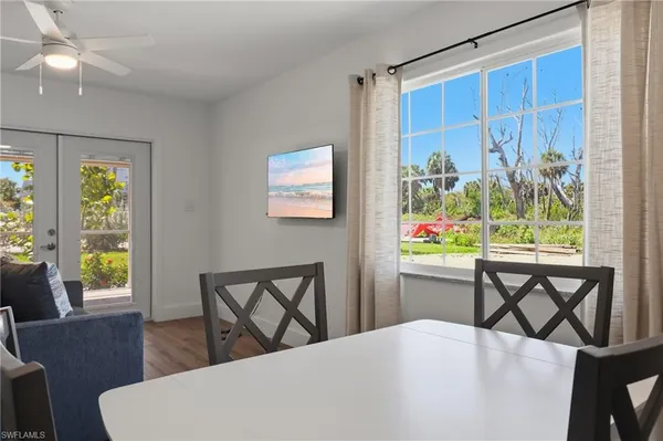 a kitchen with a table chairs refrigerator and microwave