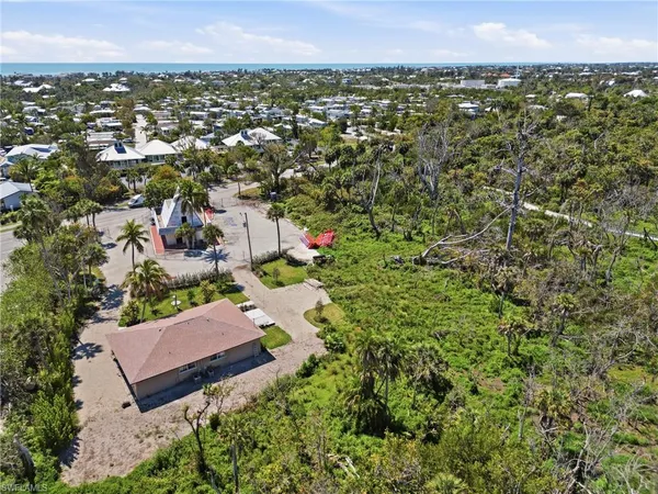 an aerial view of residential houses with outdoor space and swimming pool