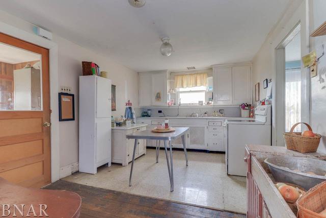21213 Litwiller Road Delavan, IL 61734 - Photo 21 of 27 a kitchen with a sink dishwasher a refrigerator and cabinets with wooden floor