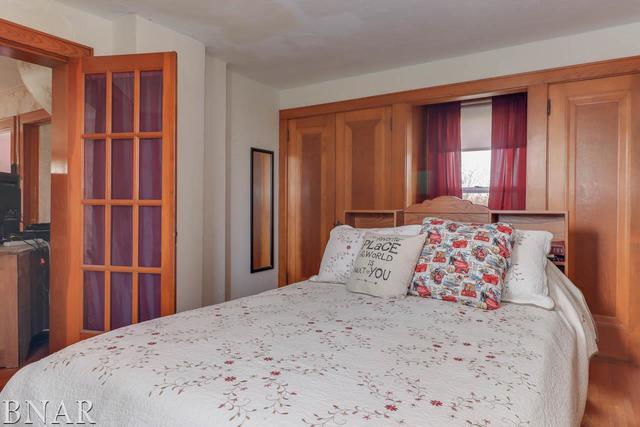 21213 Litwiller Road Delavan, IL 61734 - Photo 7 of 27 a bedroom with a large bed and wooden floor