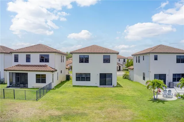 a front view of a house with a yard table and chairs