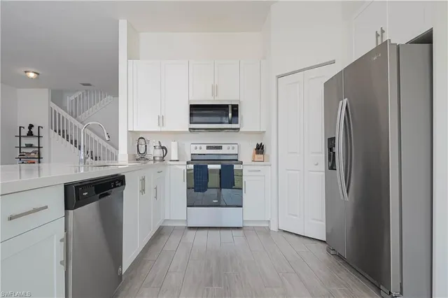 a kitchen with a refrigerator stove and sink