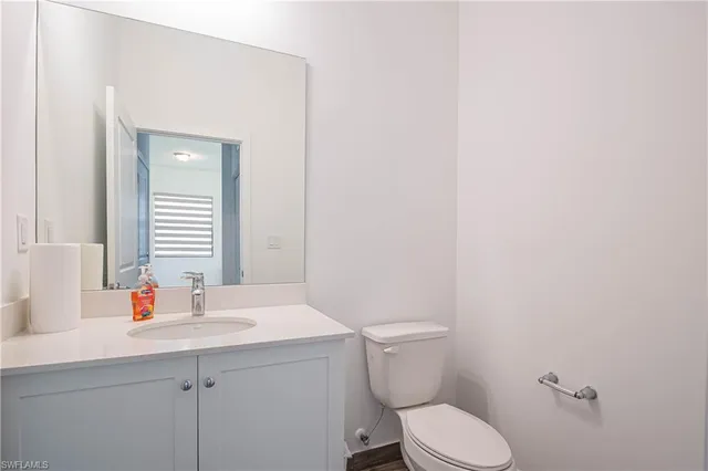 a bathroom with a sink a toilet and mirror