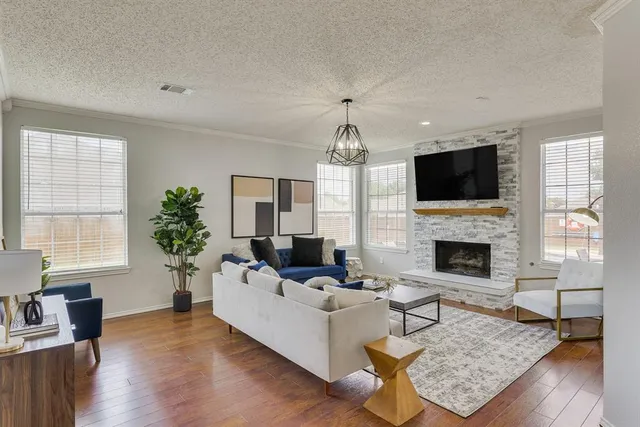 a living room with furniture a fireplace and a flat screen tv