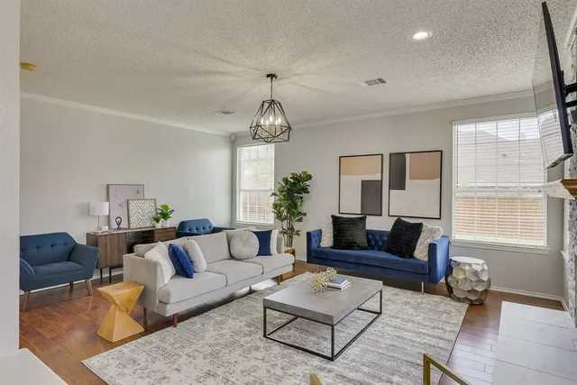 a living room with furniture a chandelier and a window