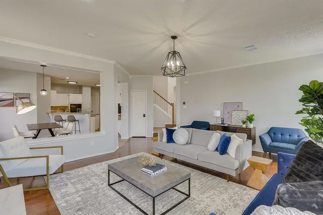 a living room with furniture and a chandelier