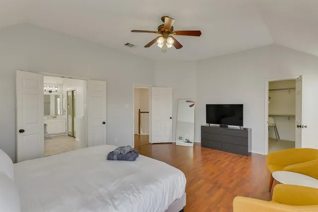 a bedroom with a bed and a flat screen tv