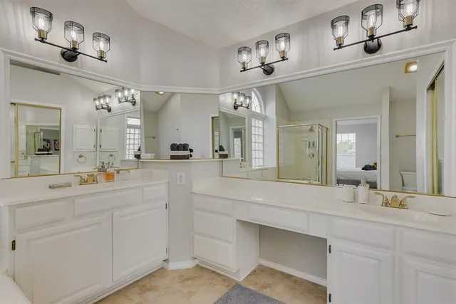 a bathroom with a sink vanity and mirror