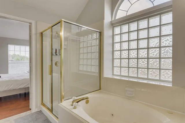 a bathroom with a bathtub and a shower