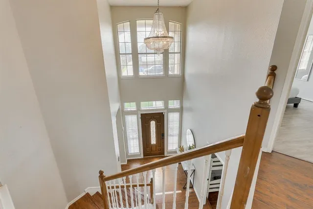 a view of a hallway with wooden floor and entryway