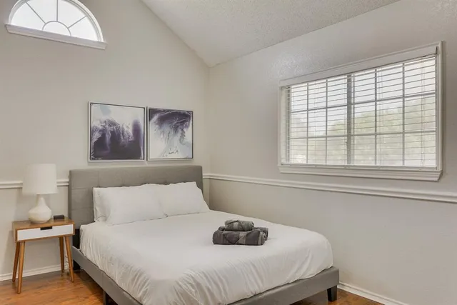 a bedroom with a bed and a window