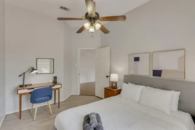 a bedroom with a bed and a chandelier